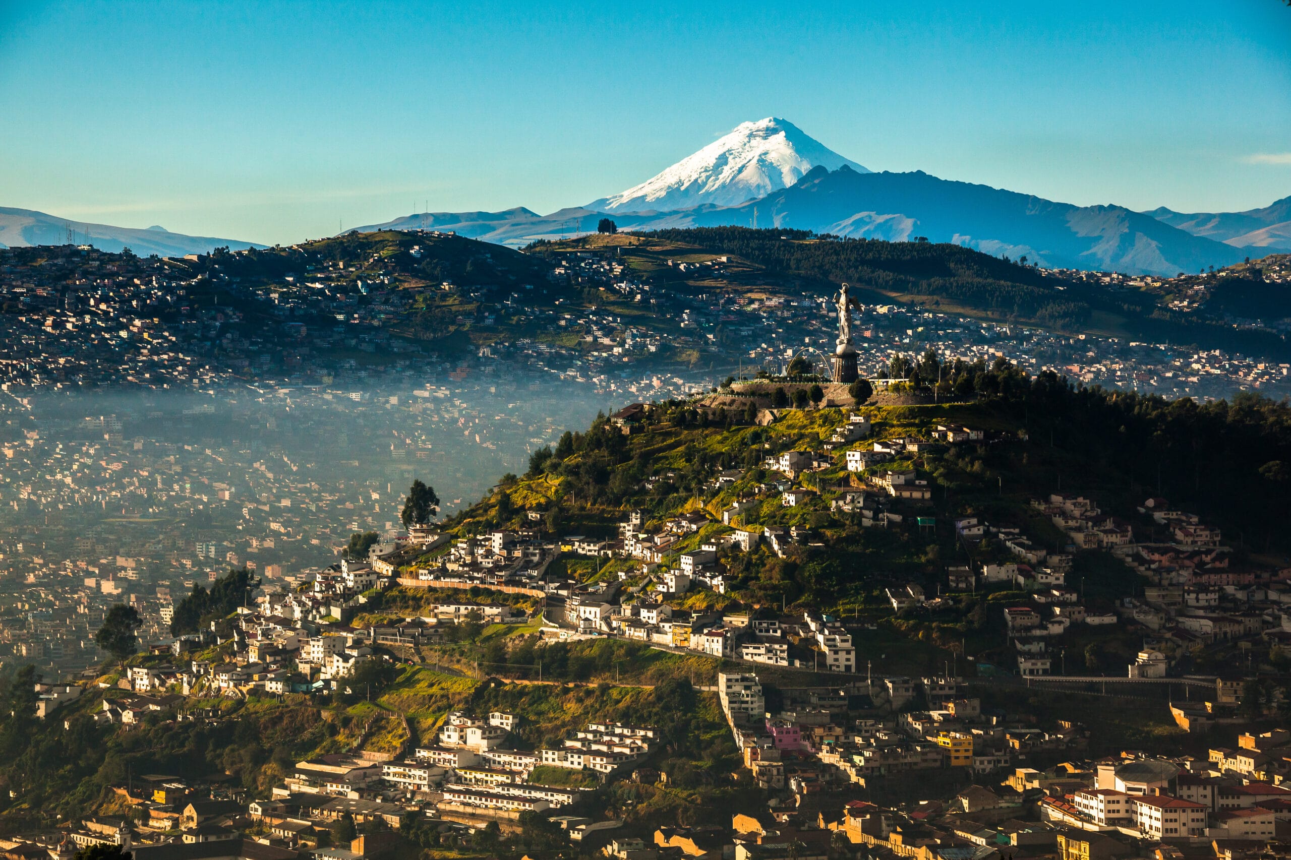 View of El Panecillo in the center of Quito with the Cotopaxi in the background
